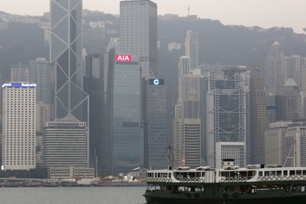 A ferry sails at Victoria Harbour in front of the Central financial district. Photo: Reuters