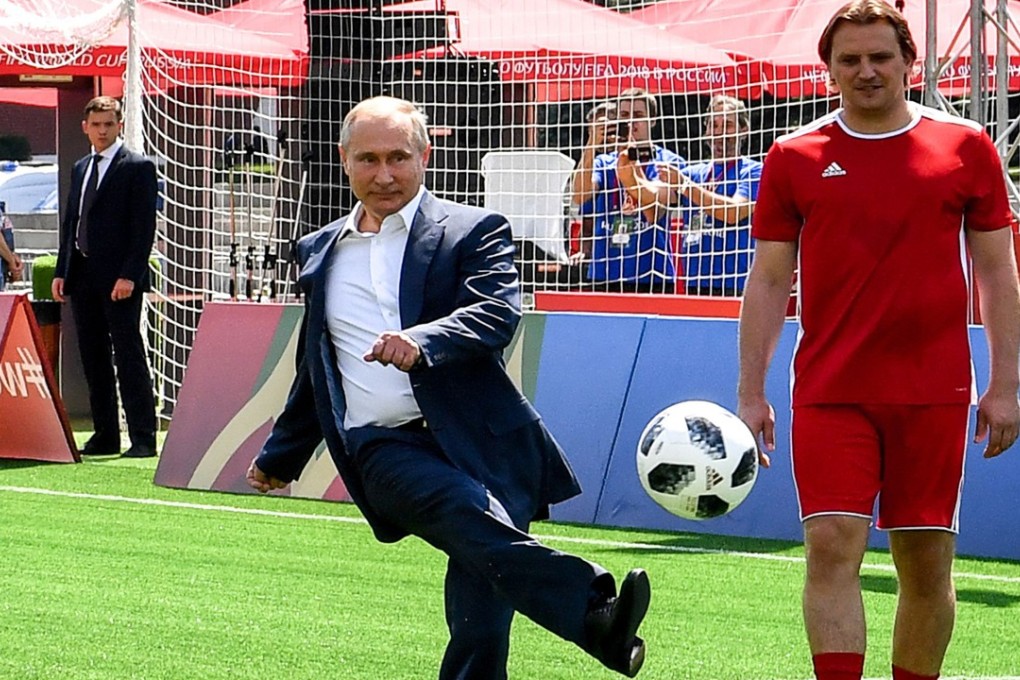 Russia President Vladimir Putin (centre) kicks a ball as he takes part in the opening of an exhibition match at the World Cup Football Park on the Red Square in Moscow. Photo: AFP