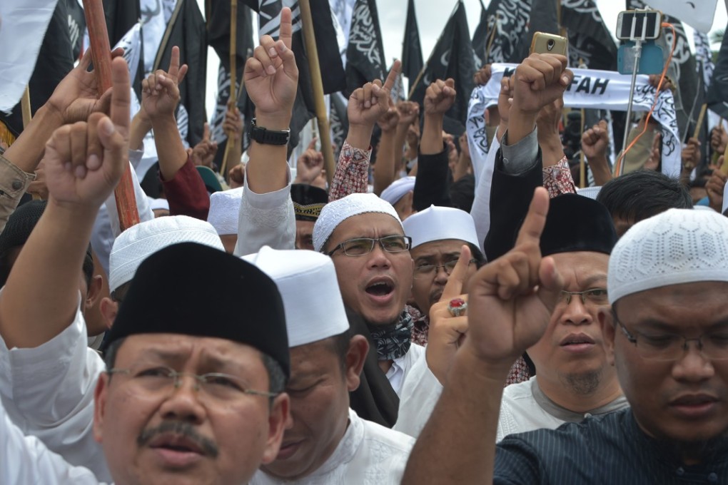 Indonesian Muslims shout slogans at the National Monument in Jakarta on February 5, 2017, during a rally to support the country’s clerics, including Rizieq Shihab, leader of the Front Pembela Islam, who helped organise mass protests against Jakarta governor and ethnic Chinese Christian Basuki Tjahaja Purnama for allegedly insulting Islam. Photo: AFP