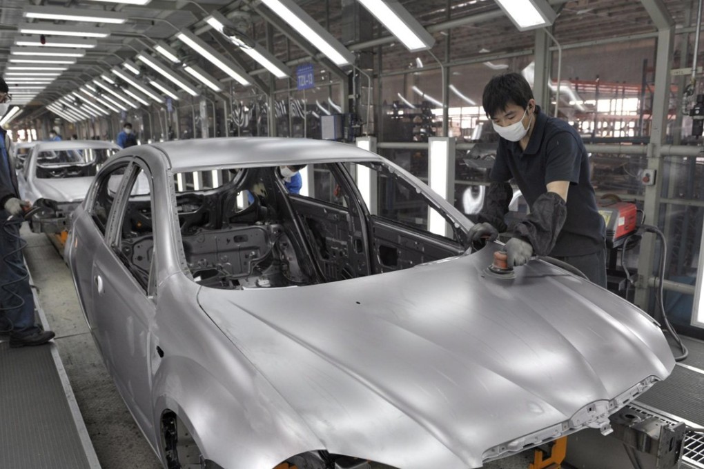 Production line workers build BMW cars at Brilliance Automotive, Shenyang City, Liaoning Province, in China in 2009. Photo: EPA