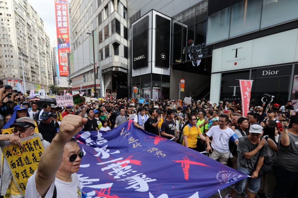 Marchers in Hong Kong’s annual July 1 rally hold a banner saying “against one-party dictatorship”, as they set off for the government headquarters from Causeway Bay. Photo: Sam Tsang