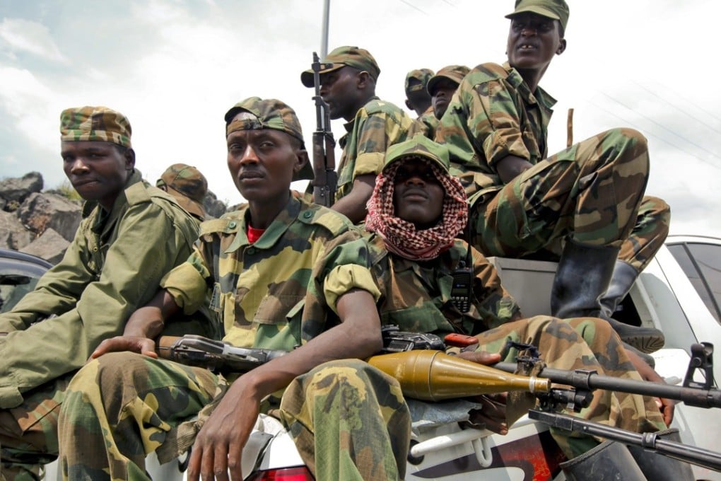 A group of M23 rebel fighters sit on a pickup truck as they prepare to leave the city, in Goma, eastern Democratic Republic of Congo, in this file photo. Photo: EPA