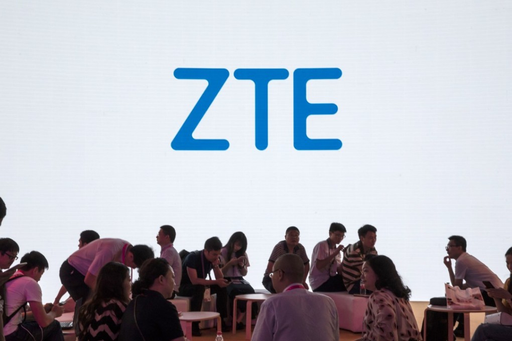 Attendees sit in front of a screen showing a ZTE Corp logo at the Mobile World Congress Shanghai in China on June 28. Photo: Bloomberg