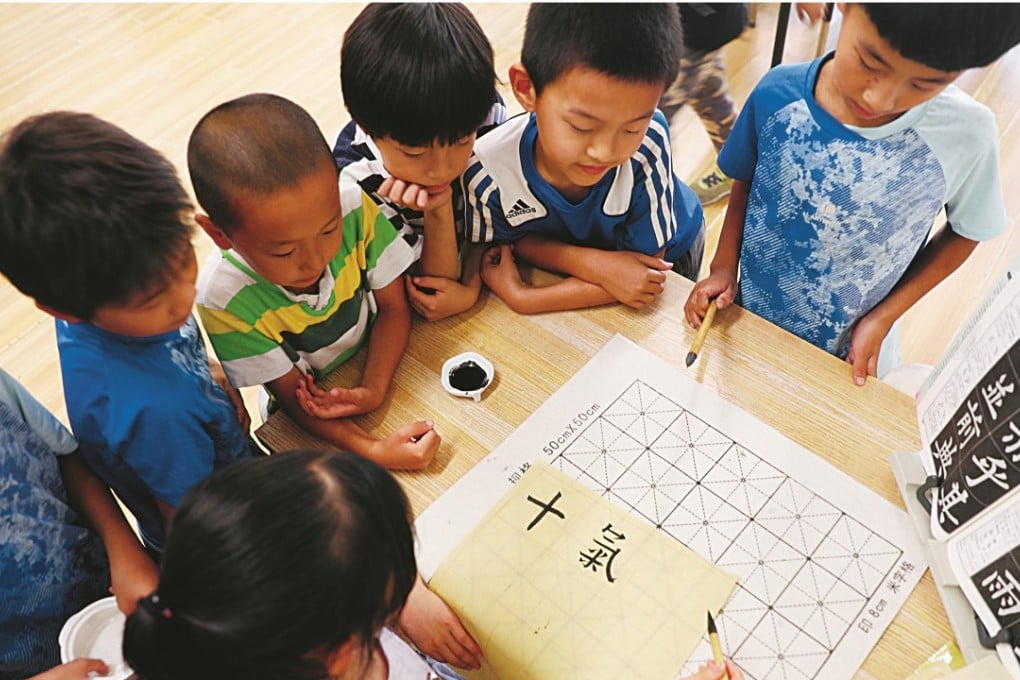 Students practise traditional Chinese calligraphy at Ririxin School in Beijing’s Changping district, which offers an alternative to traditional education. Photo: Simon Song