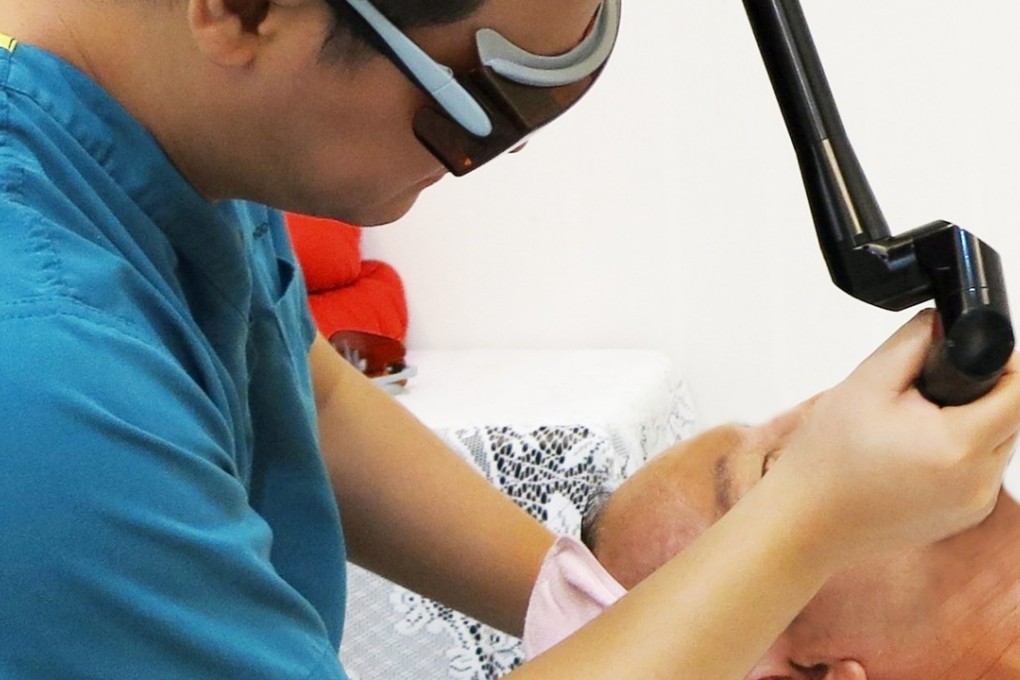 A client undergoing cosmetic laser treatment for a client. Photo: Ben Chang
