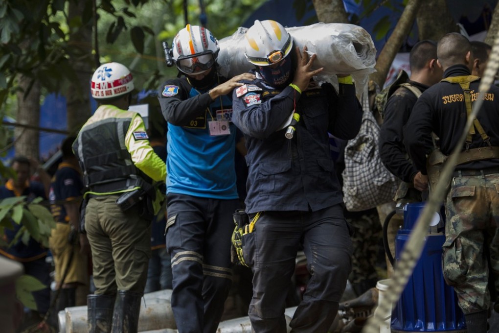 Rescue workers carry supplies during operations for 12 boys and their coach trapped in Tham Luang cave at the Khun Nam Nang Non Forest Park in Thailand. Photo: AP