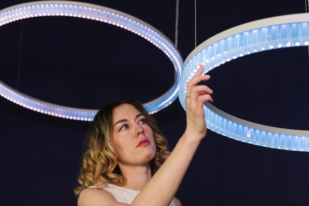Dutch designer Marjan van Aubel with her Cyanometer, a light fixture that harnesses sunlight via a portable crystal solar panel.