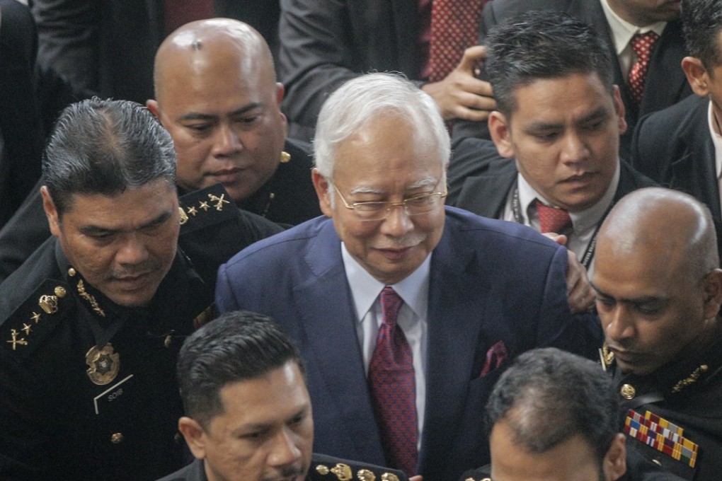 Former Malaysia Prime Minister Najib Razak (central) arrives at Kuala Lumpur High Court to face graft charges. Photo: EPA