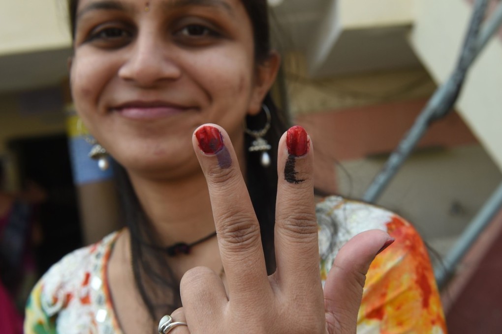 An Indian voter shows off her inked fingers after casting her ballot in the Indian state of Gujarat on December 17, 2017. Photo: AFP