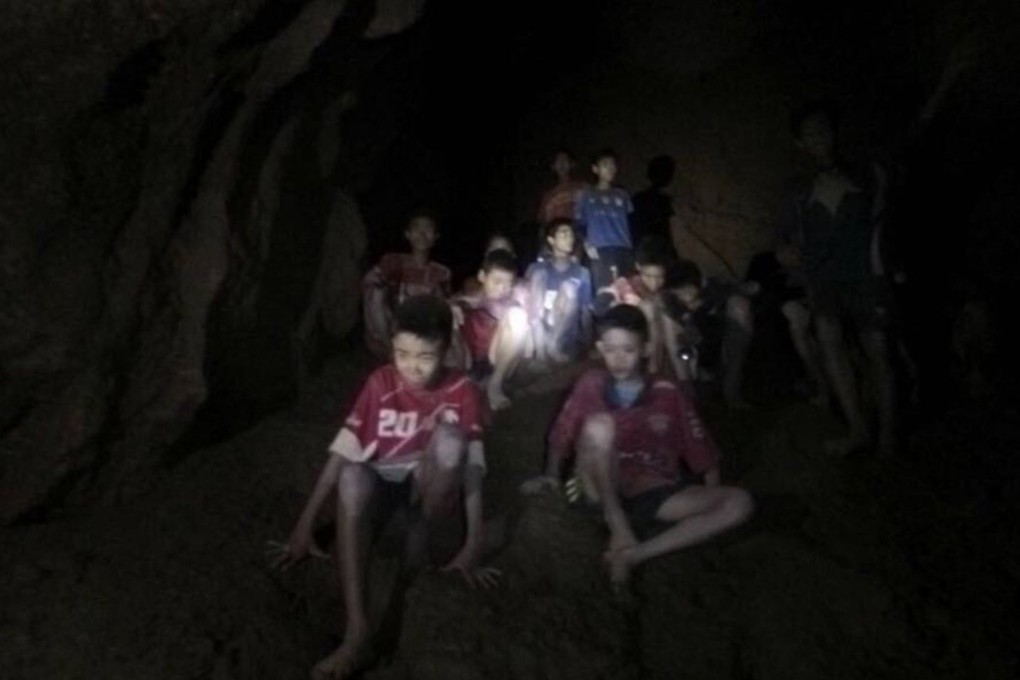 The missing boys and their soccer coach are seen shortly after they were found in a dark, partially flooded cave, in Mae Sai, Chiang Rai, Thailand, on Monday. Photo: Tham Luang Rescue Operation Center via AP