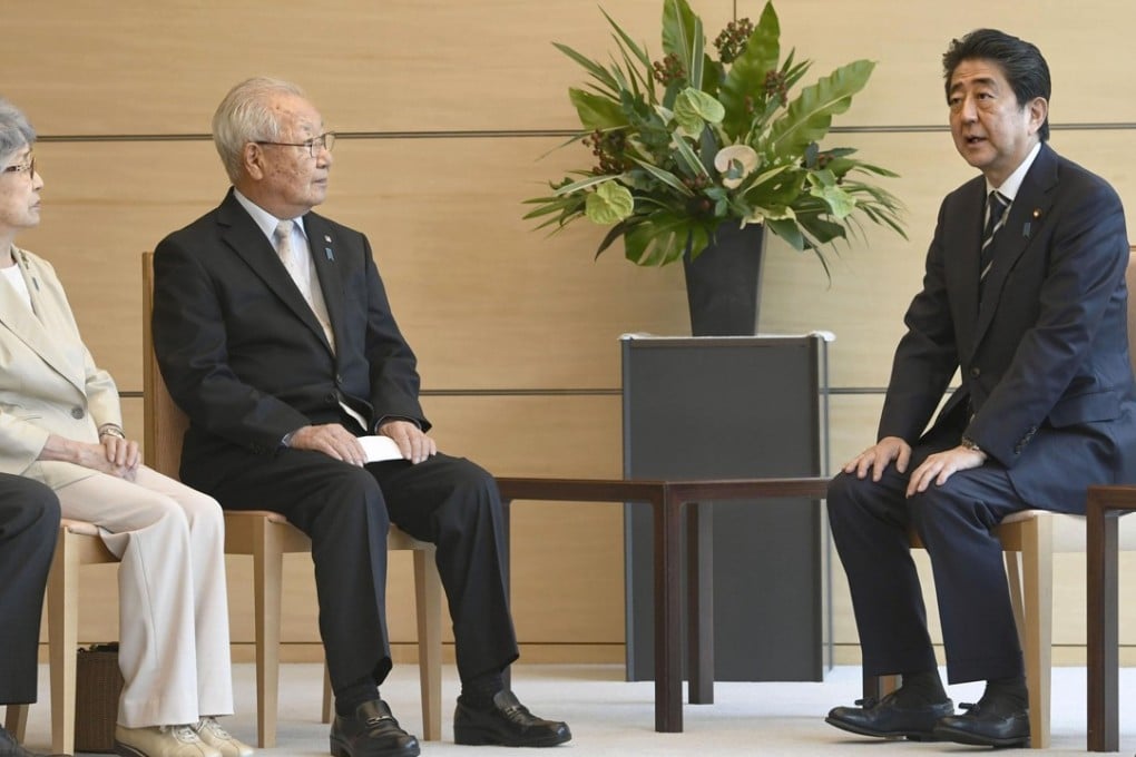 Japanese Prime Minister Shinzo Abe meets with Sakie Yokota, far left, whose daughter Megumi was claimed to be abducted by North Korea in 1977, and Shigeo Iizuka, leader of a group representing families of abductees, at the prime minister’s office in Tokyo on June 14. Photo: Kyodo