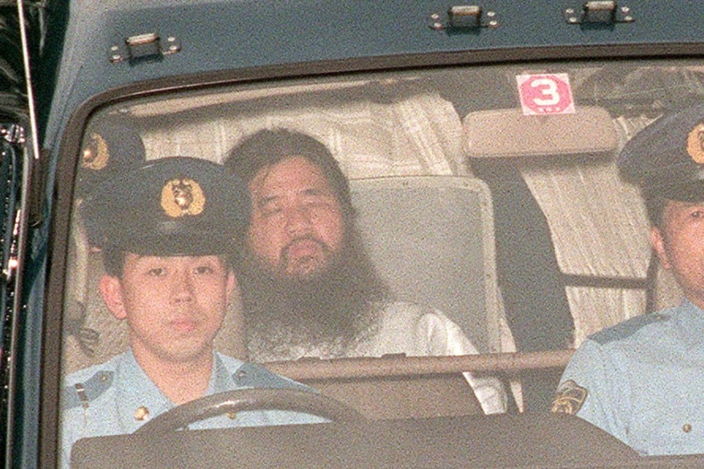 In this file picture taken on July 19, 1995, Shoko Asahara (centre), head of the doomsday cult Aum Shinrikyo, is transferred from Tokyo police headquarters to Tokyo District Court for questioning. Asahara was executed on Friday. Photo: Agence France-Presse