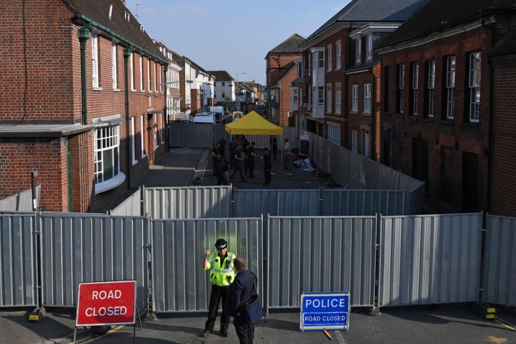 Work goes on behind the barriers across Rollestone Street, outside the John Baker House Sanctuary Supported Living in Amesbury, southern England, on Thursday, as police investigate the poisoning of two British citizens with a nerve agent. Photo: AFP