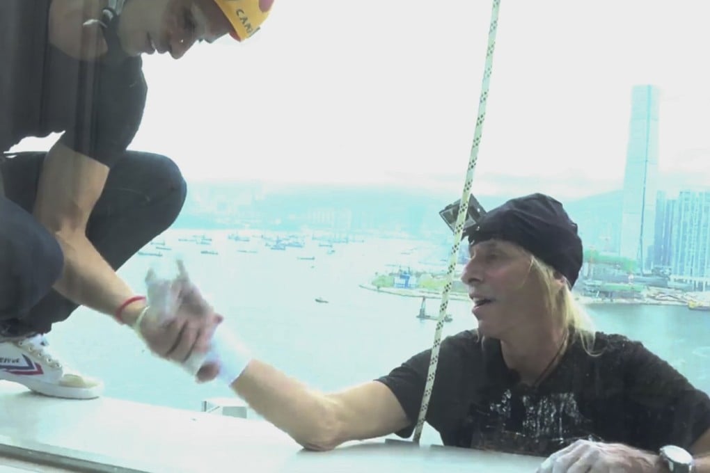 French daredevil Alain Robert reaches the top of the Hong Kong Four Seasons Hotel on Saturday morning. Photo: Skyscraper Climb