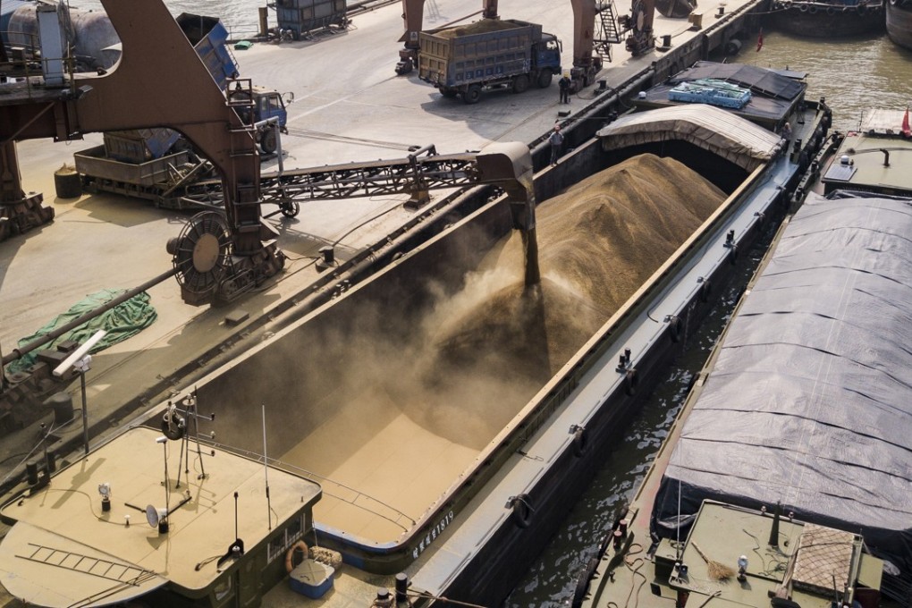 Grain is loaded into river barges docked in Nantong, Jiangsu province. China wants its traders to diversify sources of grain such as soybean. Photo: Bloomberg