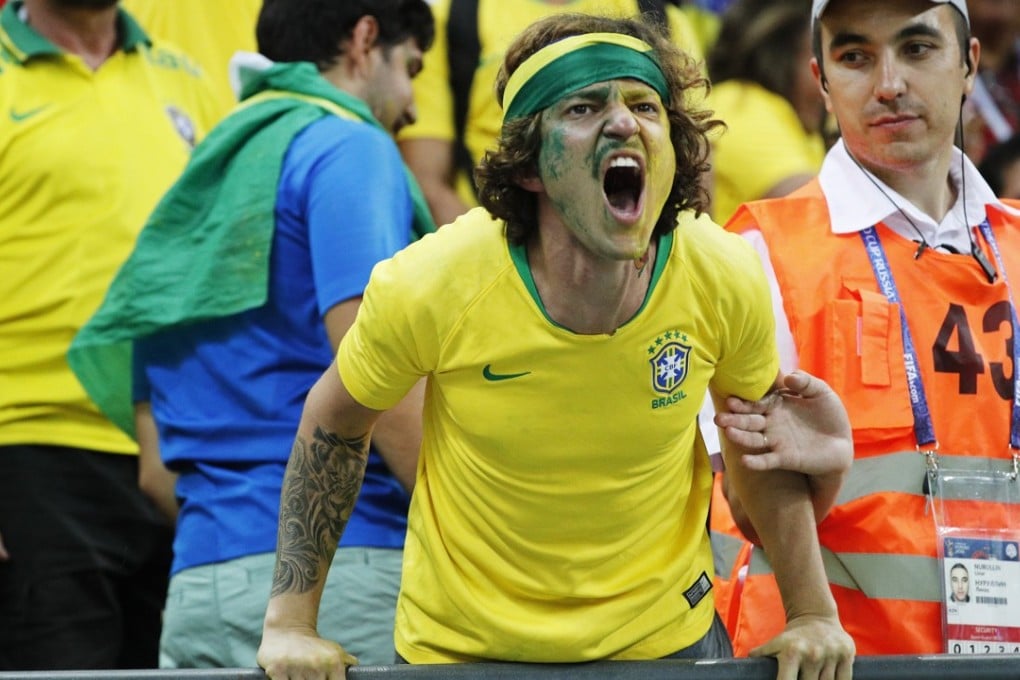 A Brazilian supporter reacts in anger after the World Cup 2018 quarter-final loss to Belgium. Photo: EPA