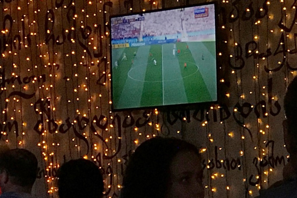 Fans watch a match on the television screen in Saint Petersburg. Photo: Reuters