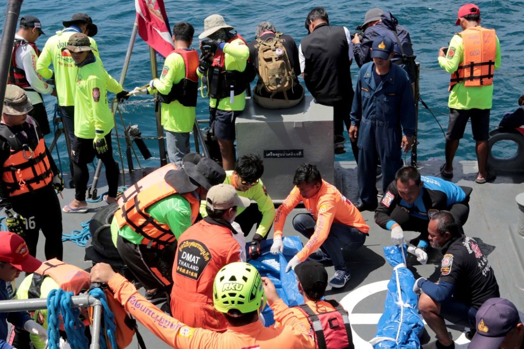 Thai rescuers carry tourists’ bodies aboard a navy vessel after it sank, as search and rescue operations continue in the seas off Phuket island, southern Thailand, on Saturday. Photo: EPA-EFE