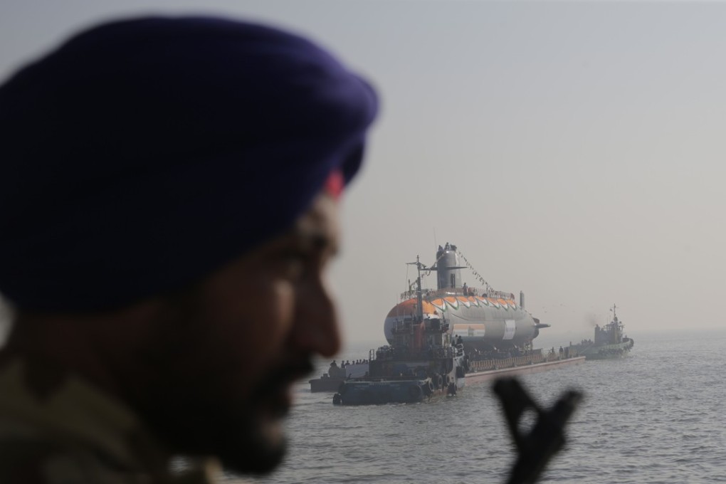 A guard looks on as the Karanj, India's third Scorpene class submarine, is set afloat during its launch at the Mazagon Dock Shipbuilders, in Mumbai on January 31. Photo: AP