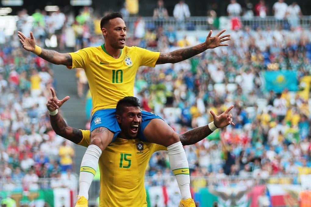 Paulinho (15) and Neymar celebrate Brazil’s opening goal against Mexico in the World Cup. Photo: EPA