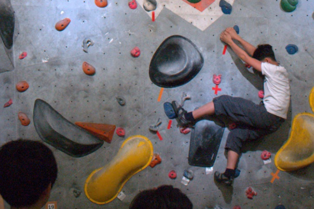 Owen Dong works his way through a bouldering problem. Photos: Mark Agnew