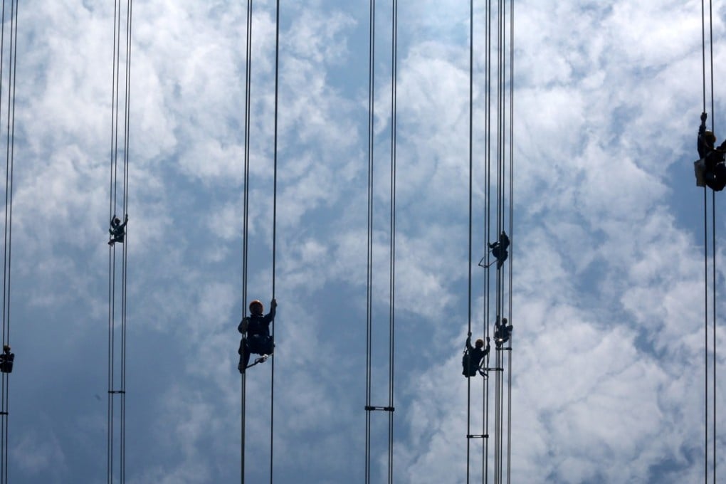 China Southern Power Grid workers inspect power cables connecting transmission towers in Dongguan, Guangdong province, on May 29. Chinese electricity demand is projected to grow 2.5 per cent by 2020. Photo: Reuters