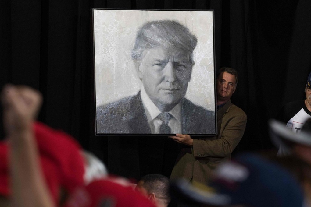 A supporter holds up a portrait of US President Donald Trump as he arrives to speak during a rally in Great Falls, Montana, on July 5. Photo: AFP