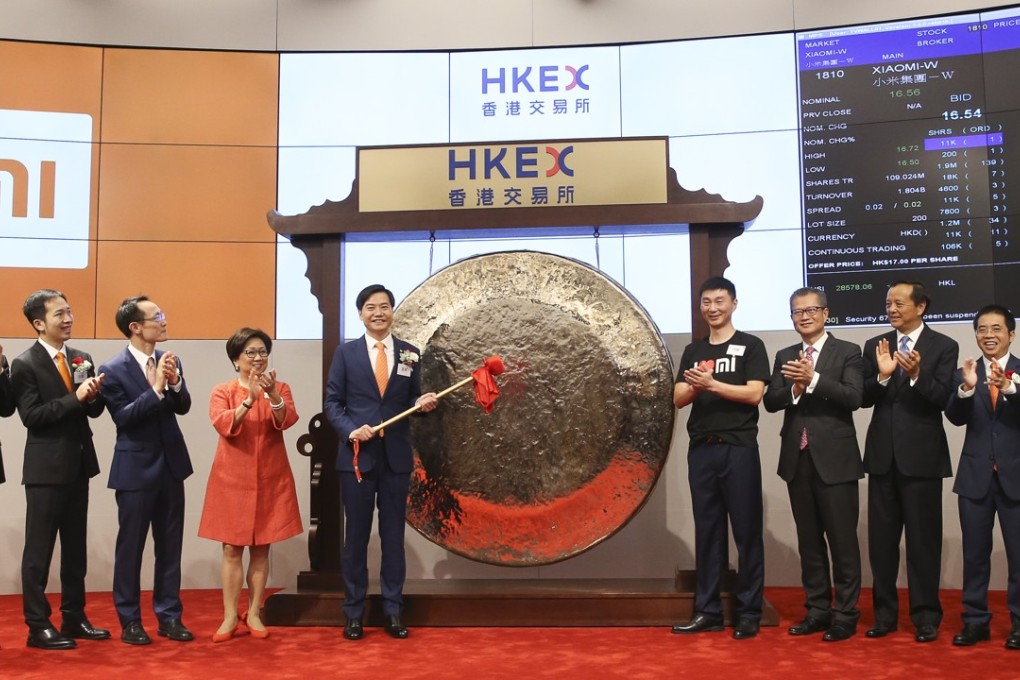 Xiaomi founder, chairman and CEO Lei Jun hits the gong during the listing of the company in Hong Kong on Monday. Photo: Sam Tsang