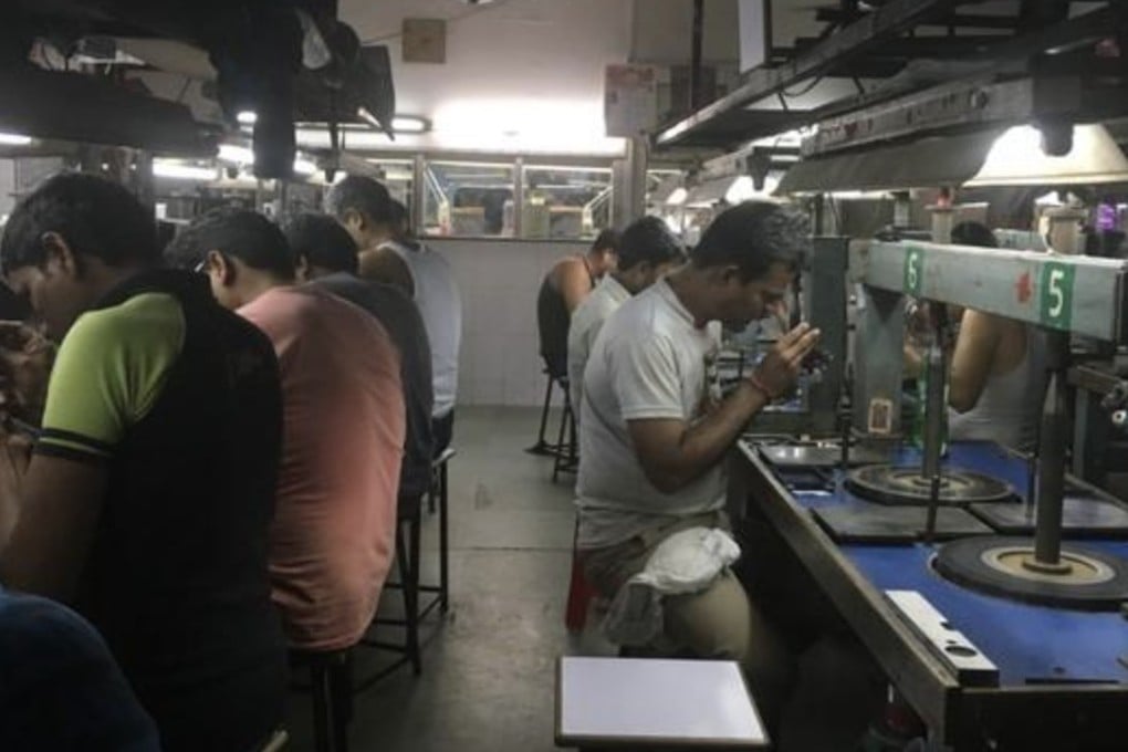 Workers in a mid-sized diamond polishing factory in Mumbai, India. Photo: Thomson Reuters Foundation