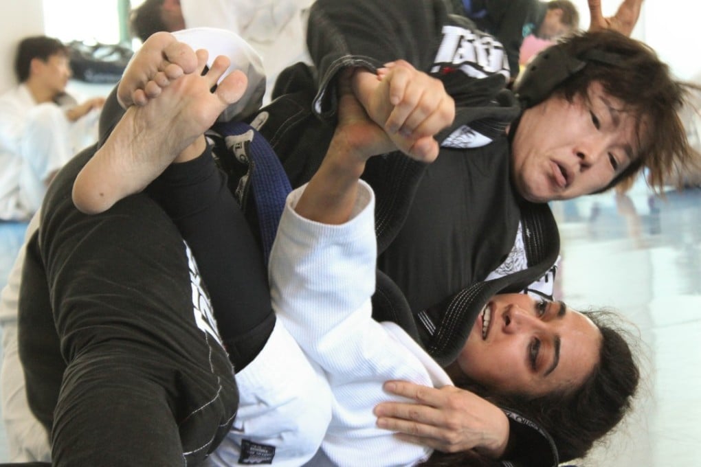 Brazilian jiu-jitsu brown belt Nilofer Mallick (bottom), an airline pilot living in Seoul, grappling with an opponent. Photo: Courtesy of Nilofer Mallick