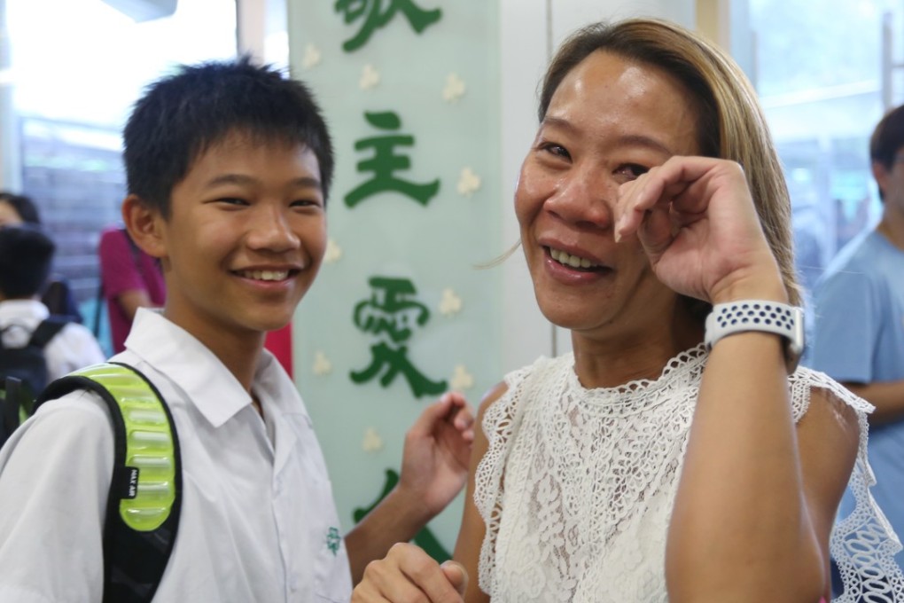 Cheng Suk-fan (right) cries tears of joy after discovering her son Yuen Pak-ngai, 12, has been accepted by Choi Hung Catholic Secondary school, his first choice. Photo: Xiaomei Chen
