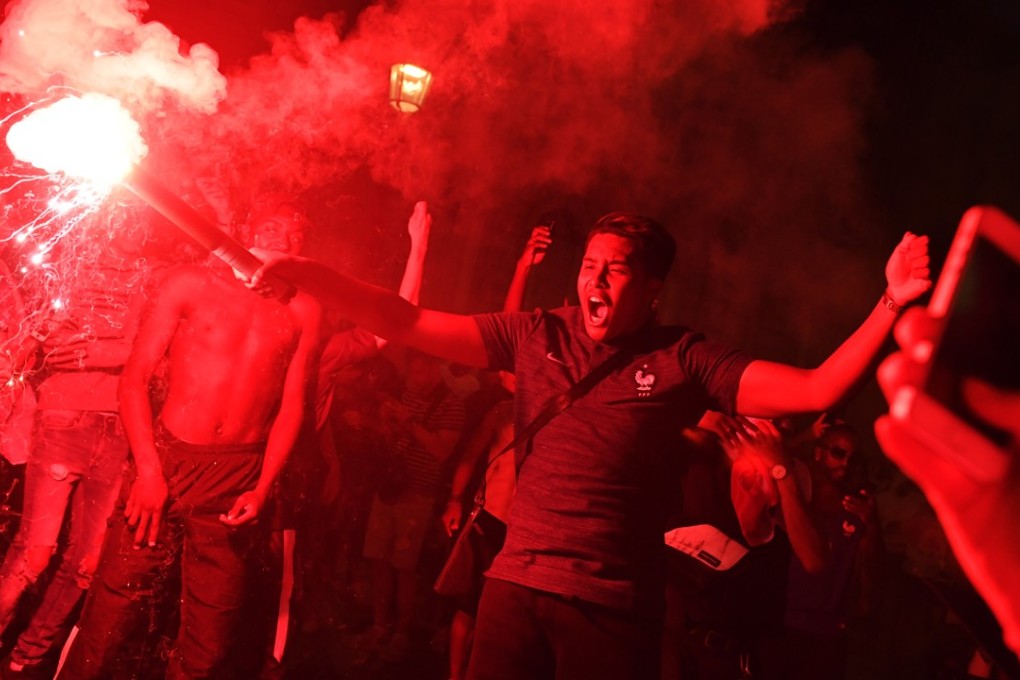 French supporters celebrate on the Champs Elysees their team’s victory after the World Cup 2018 semi-final win over Belgium. Photo: EPA
