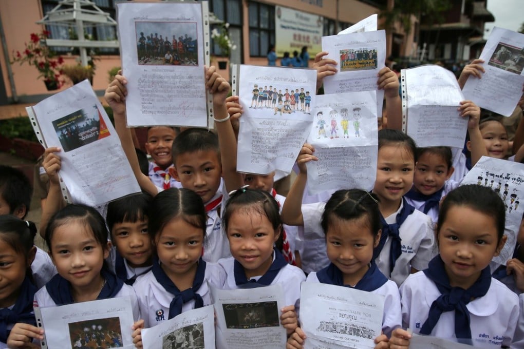 Students celebrate in front of Chiang Rai Prachanukroh hospital, where the 12 soccer players and their coach rescued from the Tham Luang cave complex are being treated. Photo: Reuters