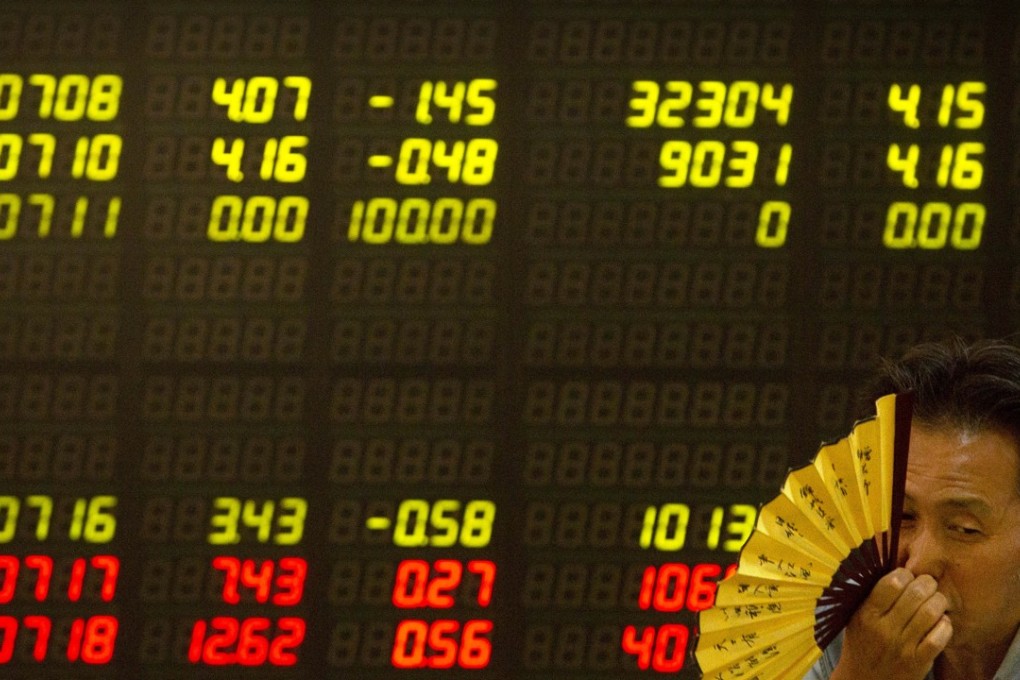 A Chinese investor monitors stock prices at a brokerage house in Beijing on July 6. Photo: AP