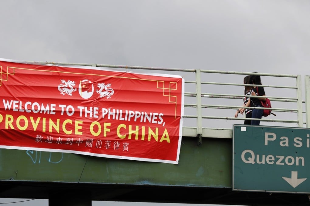 A banner bearing the words “Welcome to the Philippines, Province of China” hanging from a bridge in Taguig, south of Manila. Photo: EPA