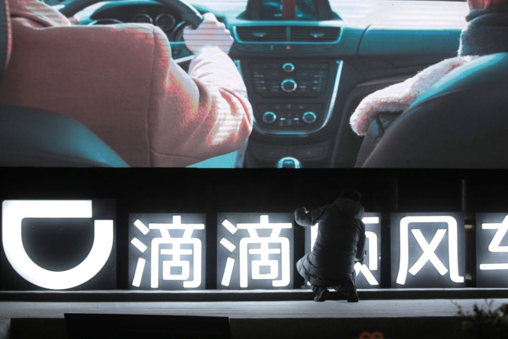 A man is seen in front of a Didi sign before a promotional event of its Hitch service for the Spring festival travel rush, in Beijing, China, 2018. Photo: Reuters