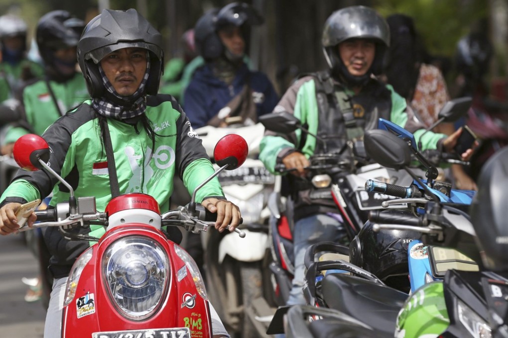 Go-Jek drivers wait for customers in Jakarta, Indonesia. The Indonesian ride-hailing service says it will expand into Thailand, Vietnam, Singapore and the Philippines in the next few months. Photo: AP