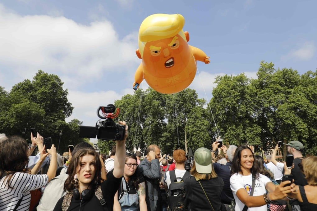 Protesters gather around a giant balloon caricature of Donald Trump in Parliament Square, London on July 13, 2018. Photo: AFP