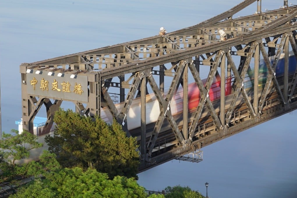 Trucks cross the Friendship Bridge over the Yalu River from North Korea to Dandong, Liaoning province, China. Trade between the two countries declined sharply in June. Photo: Reuters