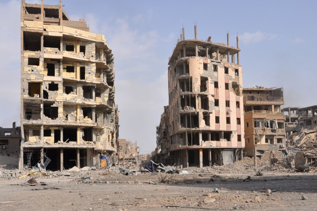 File photo of a damaged street in Deir Ezzor. Photo: AFP