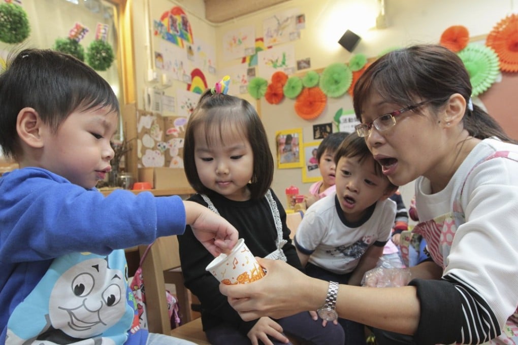 A teacher offers children salt to taste during a kindergarten class at what is now the Education University of Hong Kong, in Tai Po in November 2015. Kindergartens should follow a child-led approach, rather than burden both children and teachers with tests and paperwork. Photo: Bruce Yan