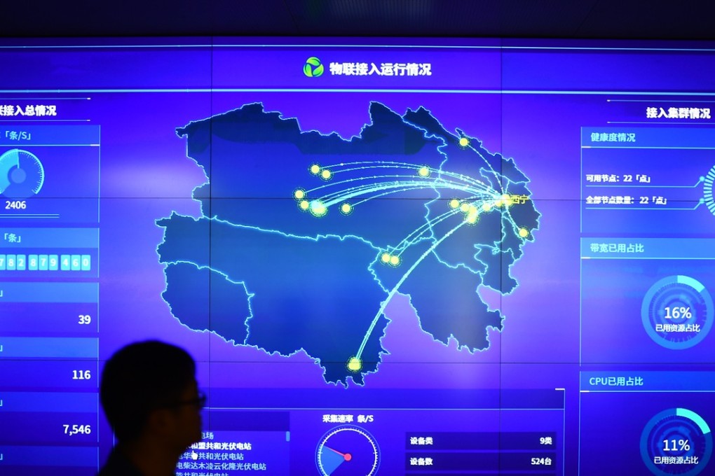 A staff member walks past a data screen at a new energy and big data branch of the State Grid Qinghai Electric Power Company in Xining, northwest China. Photo: Xinhua