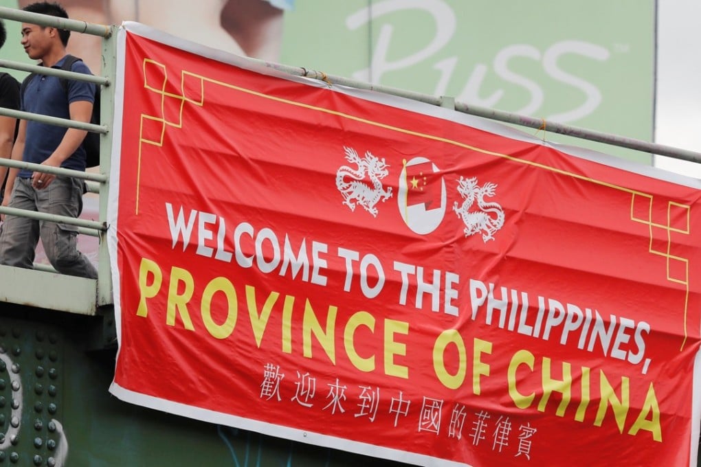 No one knows who has been hanging these banners on bridges in Manila. Photo: Reuters