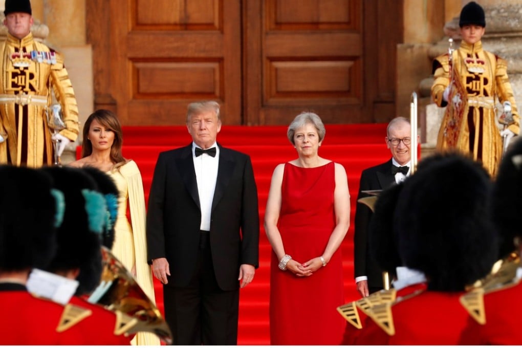 British Prime Minister Theresa May and her husband Philip stand together with US President Donald Trump and first Lady Melania Trump at the entrance to Blenheim Palace near Oxford on Thursday. Photo: Reuters