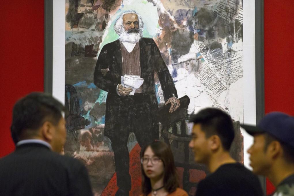 Visitors look at paintings at an exhibition commemorating the 200th anniversary of the birth of Karl Marx, at the National Museum in Beijing on May 5. In a speech on May 4, President Xi Jinping instructed all party members to adopt the reading of Marxist works and the understanding of Marxist theories as a “way of life” and a “spiritual pursuit”. Photo: AP
