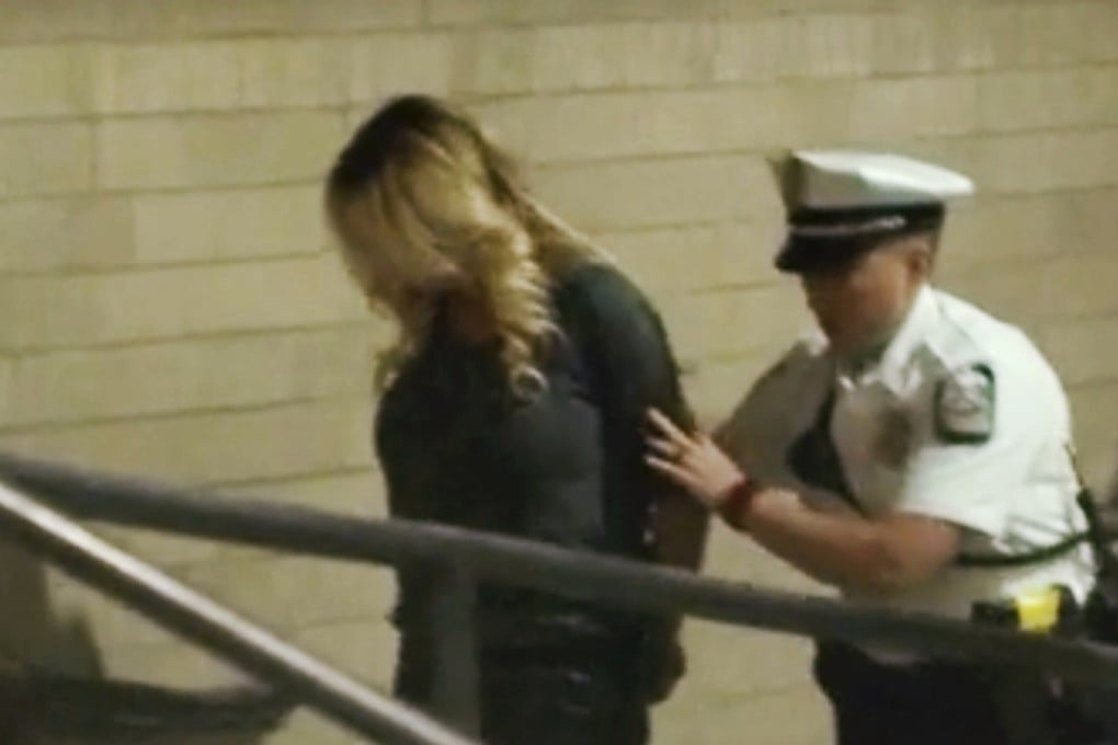 In this frame from a video, the porn actress Stormy Daniels is led into jail in Columbus, Ohio, after being taken into custody at a strip club. She was accused of letting patrons touch her, a violation of a state law, but the charges were dismissed. Photo: WBNS via AP