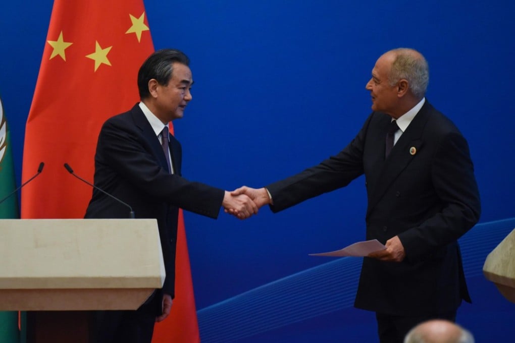 Chinese Foreign Minister Wang Yi and Arab League Secretary-General Ahmed About Gheit shake hands at the end of a joint news conference during the eighth Ministerial Meeting of the China-Arab States Cooperation Forum in Beijing on Tuesday. 2018. Photo: AFP