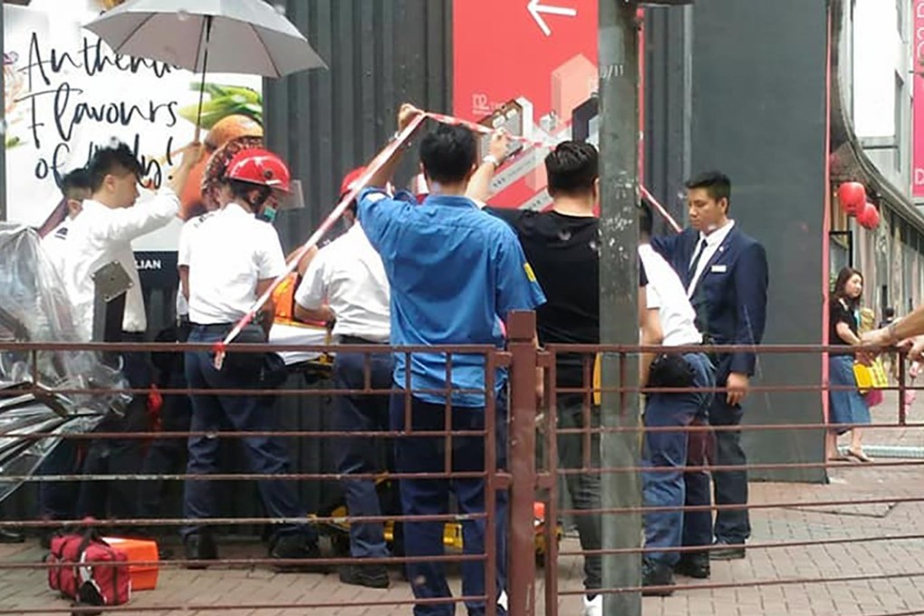 Emergency services put the injured woman on a stretcher after she was struck by a marquee that fell from the 11th floor of D2 Place in Cheung Sha Wan. Photo: Facebook