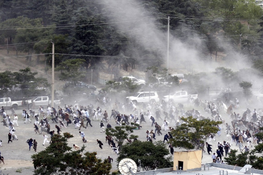 People run after an explosion at a funeral in Kabul, Afghanistan. Photo: EPA