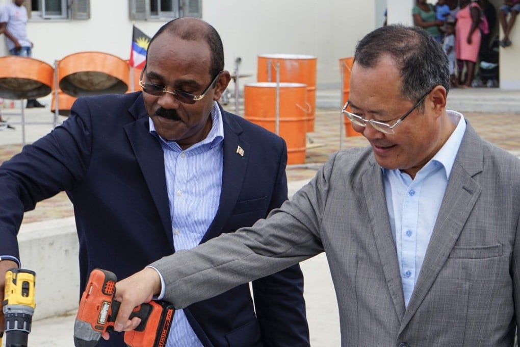 Antigua & Barbuda's Prime Minister Gaston Browne and China's ambassador to the country, Wang Xianmin, lay a ceremonial nail in Codrington, Barbuda. Photo: AFP